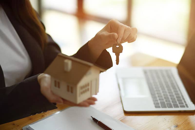 Picture of a person holding a house and keys after pseaking with Five Dock Finance